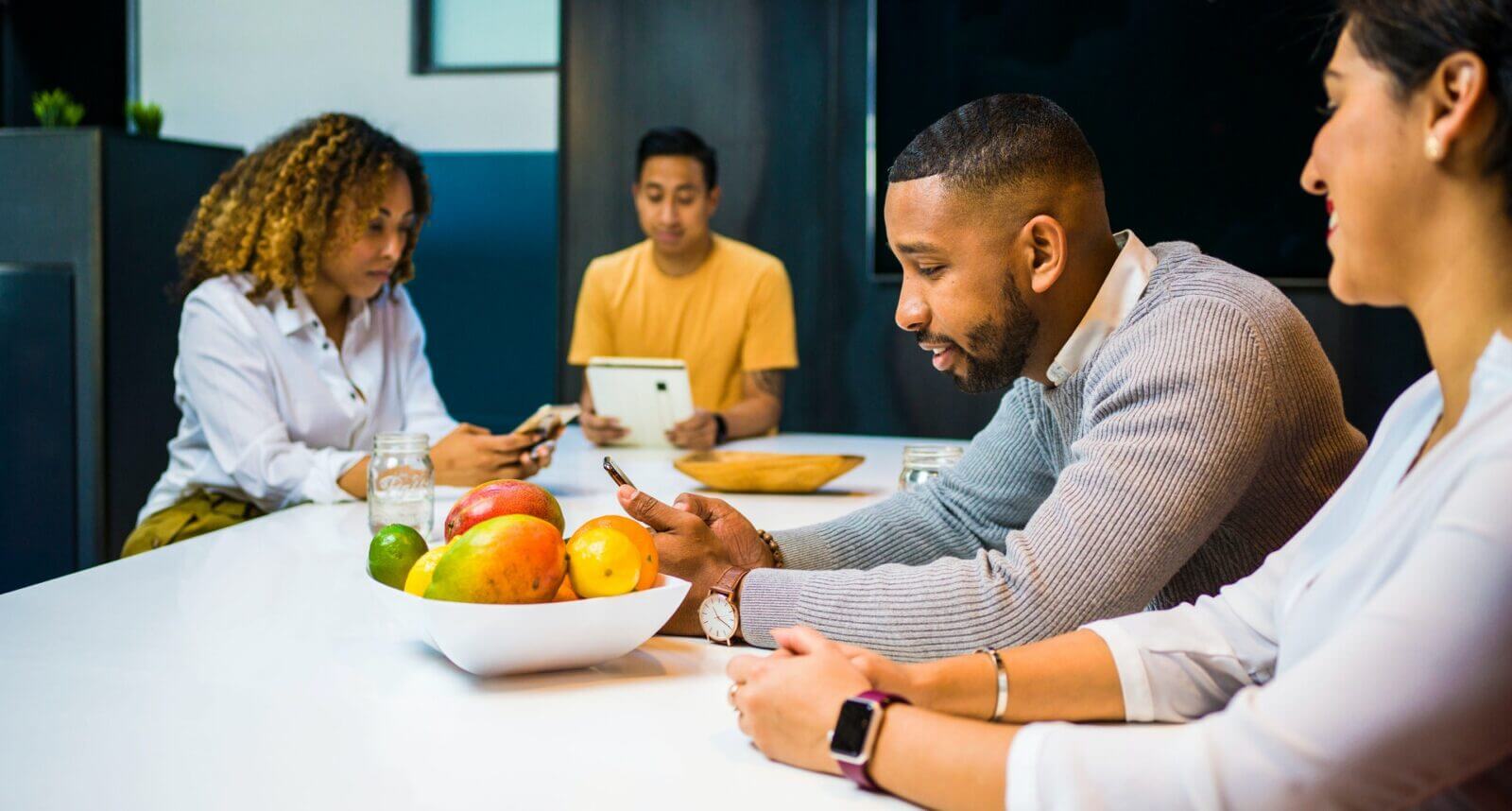Groupe d'entrepreneurs africains autour d'une table avec des fruits.